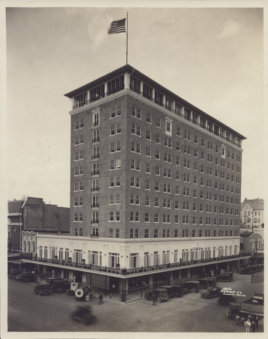 Photo of building several stories taller than surroundings on a downtown street corner