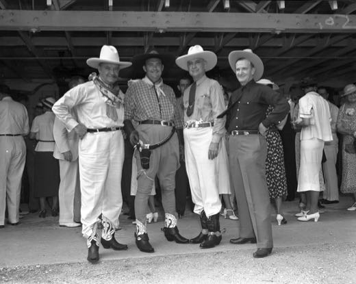 Four men including Whiteman in cowboy attire