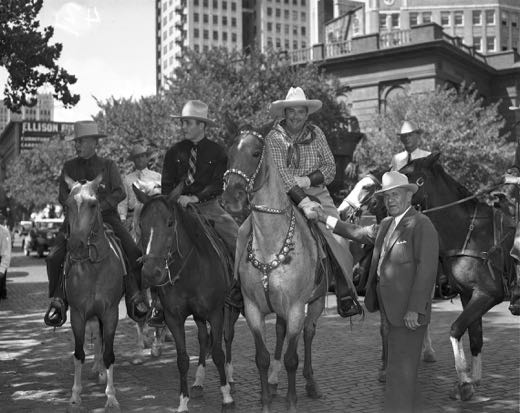 Whiteman on horseback shaking hands with mayor