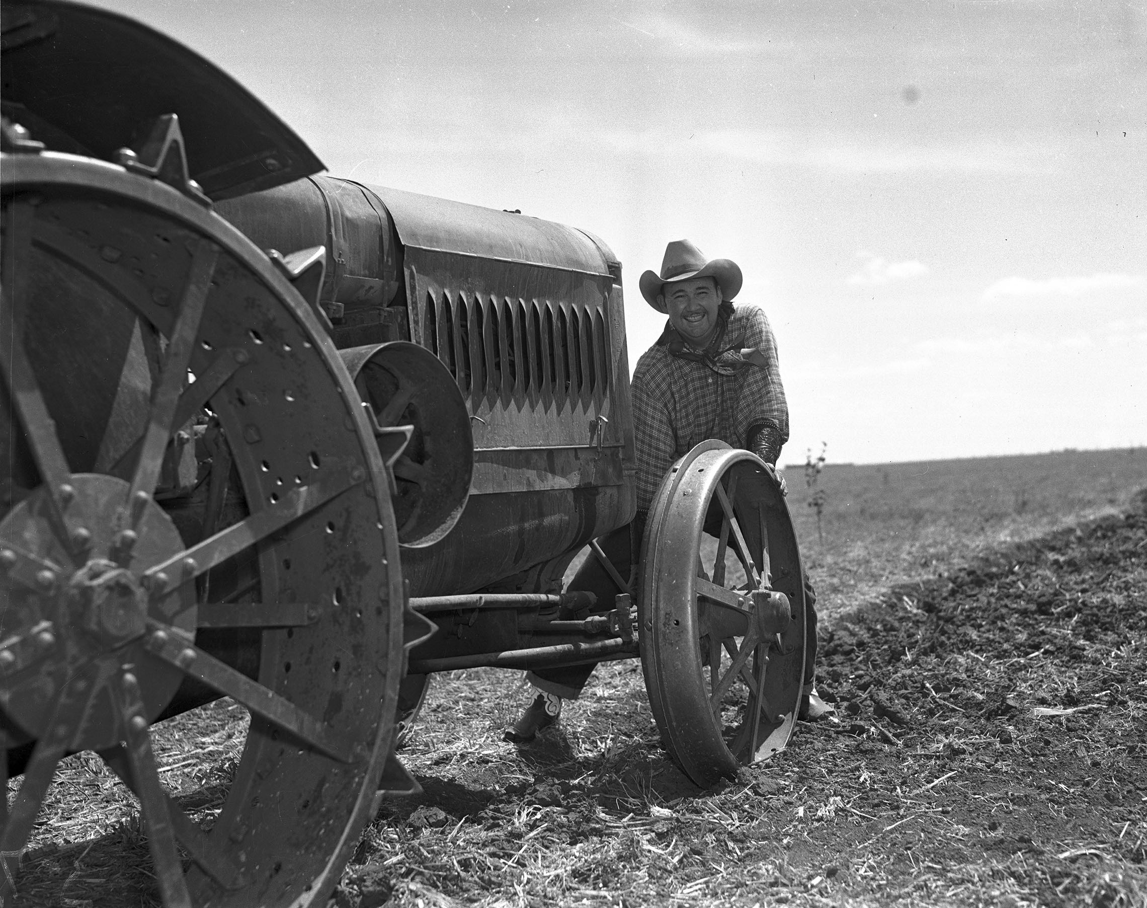 Whiteman in front of a tractor